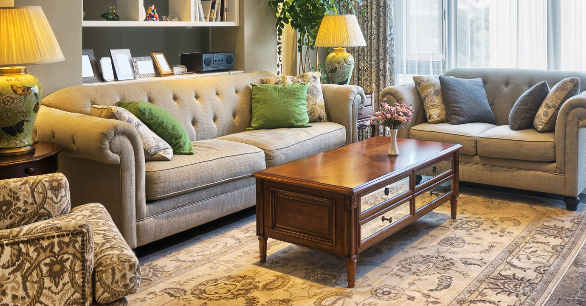 Two couches and a coffee table with lamps on two end tables