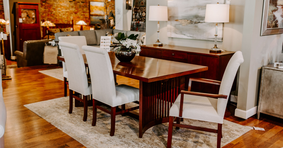 A beautiful wooden dining table with 4 white chairs around