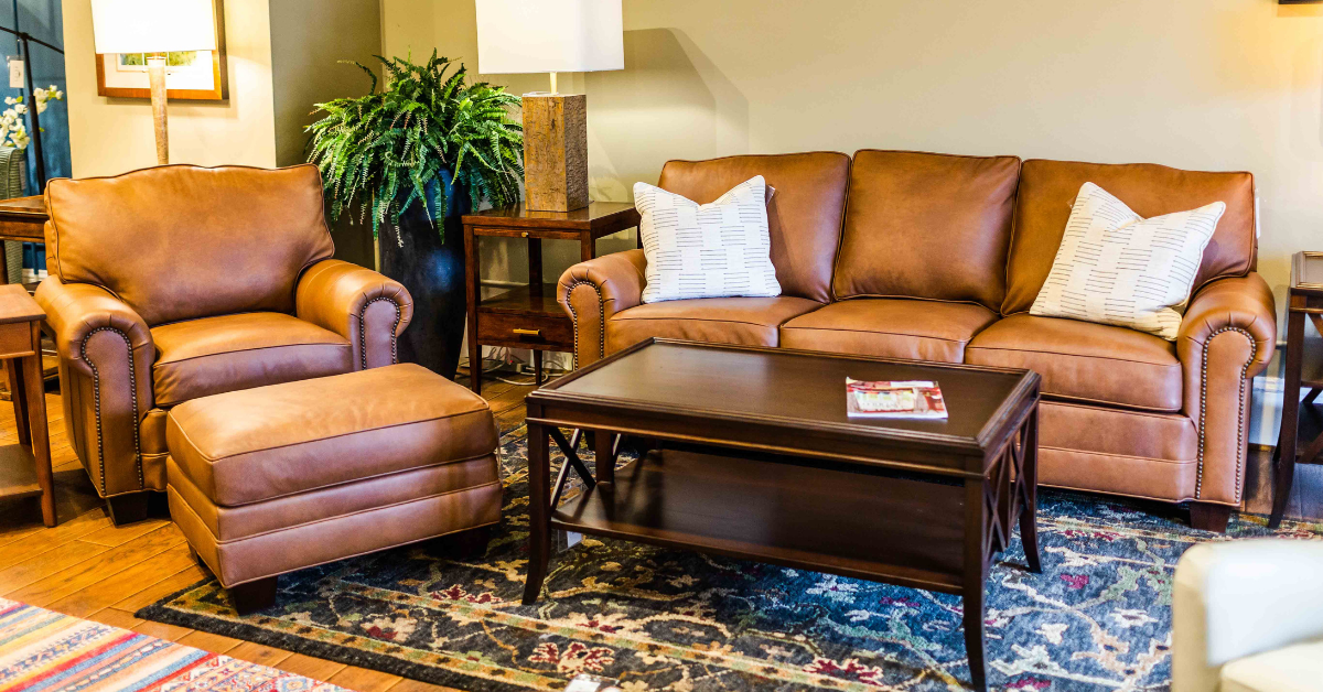 a leather living room set with a dark brown coffee table in the middle