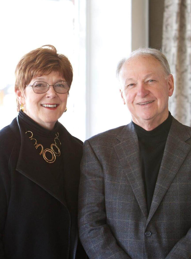 Bill Waide and Andrea Reid, owners of Reid's Fine Furnishings smiling for a portrait
