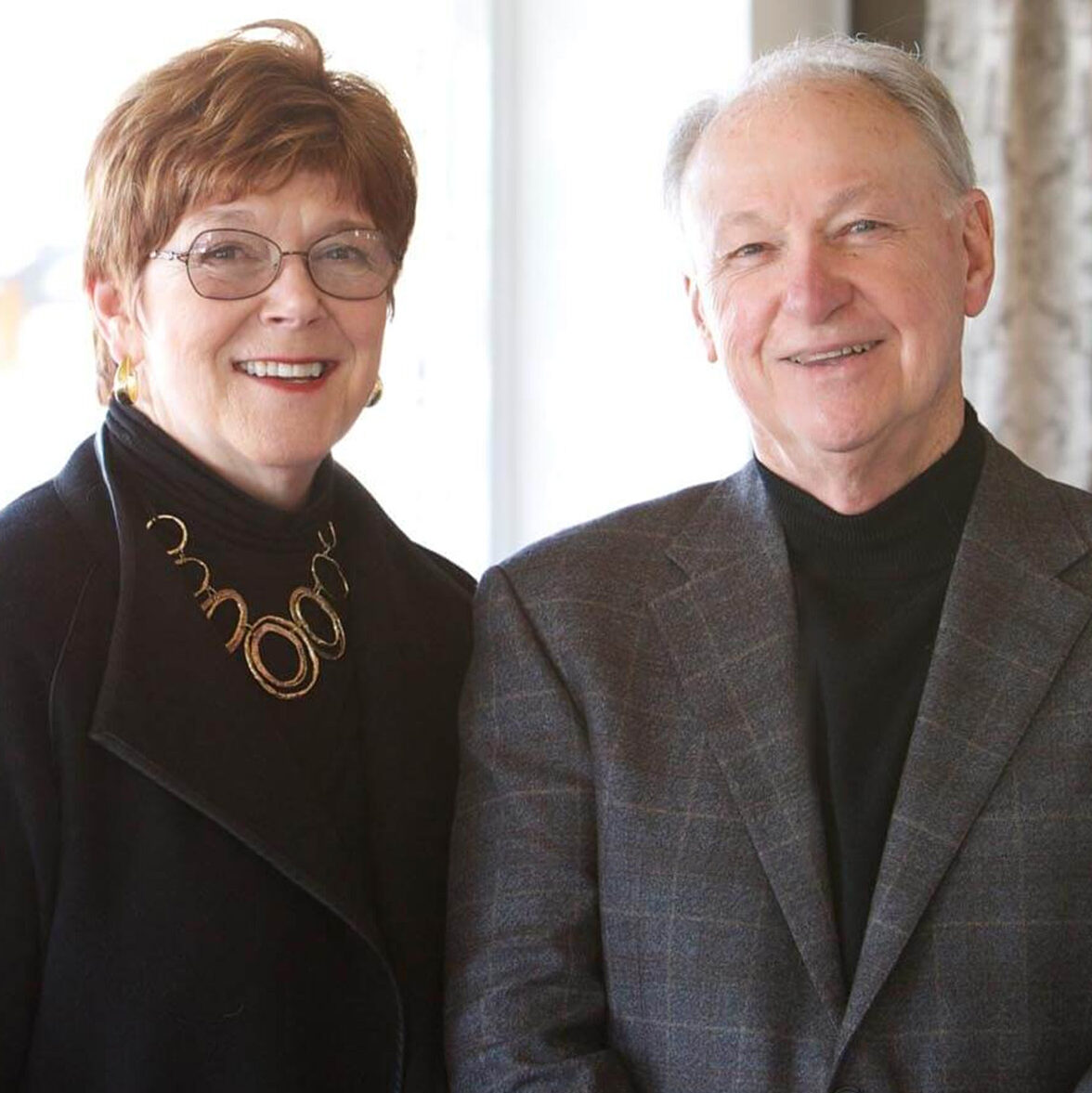 Bill Waide and Andrea Reid, owners of Reid's Fine Furnishings smiling for a portrait