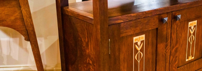 A dresser with two door handles 