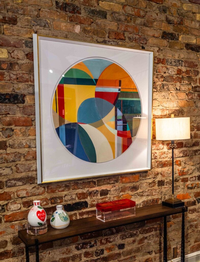 Colorful wall art displaying geometric shapes within a circle